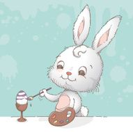 Bunny painting an easter egg