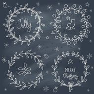 Christmas wreaths set on blackboard