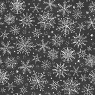 chalkboard black and white snowflakes seamless pattern background