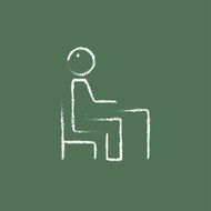 Student sitting on a chair in front of the desk