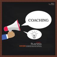 Hand holding megaphone with coaching word on chalkboard coachin