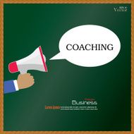 Hand holding megaphone with coaching word on chalkboard coachin N2