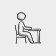 Student sitting on a chair in front of his table