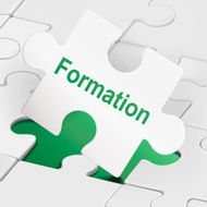 formation word on white puzzle pieces