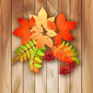 Autumn background with leaves on a wood texture