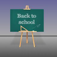 Green school board with chalk on a tripod