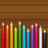Color pencils on wooden background