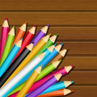 Color pencils on wooden background N2