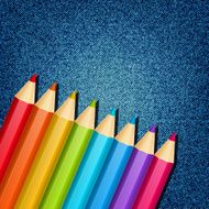Color pencils on jeans background