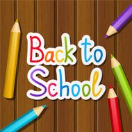 Back to school message on wooden background
