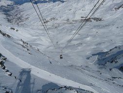 cable car among snow-capped mountains