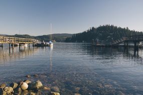 Docks with boats on the beautiful lake scene with hills with plants