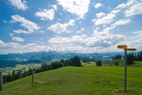 light clouds over green hill in summer