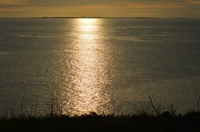 ocean reflection sun ray shore outline