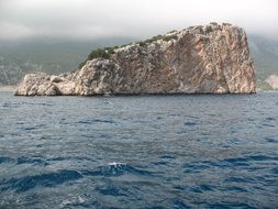 Stone Island in the sea against the backdrop of a cloudy sky