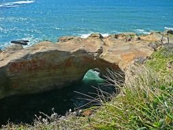 arch in rock on ocean coast