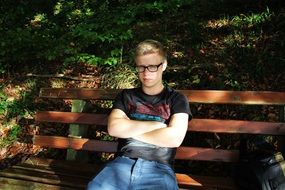 boy sitting on a bench in the Park