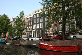 Multi-colored boats along the canal in Amsterdam