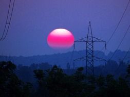 sunset above the electric pylon tower