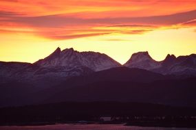 wonderful orange sunrise over romsdalsalpene mountains, norway