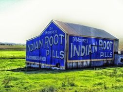 blue barn on a green field in australia
