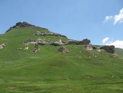 large stones on a green hill