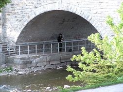 saxophone music under a bridge