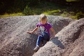 child playing in the sand