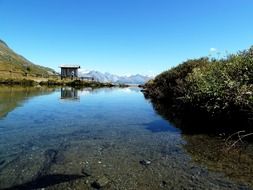 stones in the water near the mountains