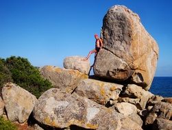 man on stone sea rock