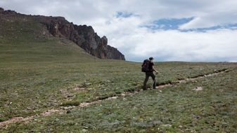 hiker on green mountain