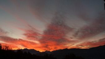 red sunrise over black silhouettes
