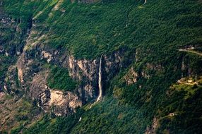 waterfall on green cliff aerial view