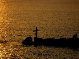 fishing man at sunset