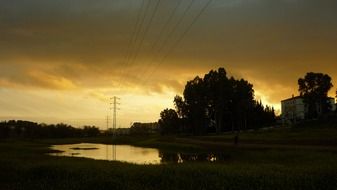 small pond under the power lines at sunset