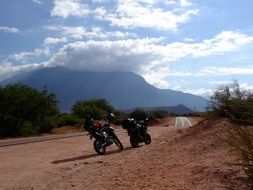 parked motorbikes on the side of a road
