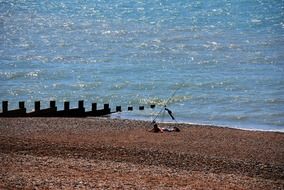 fisherman fishing and resting on the beach