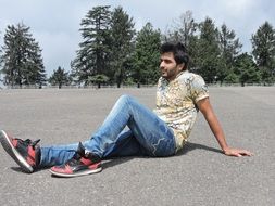 young man resting on the road