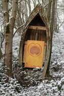 wooden sculpture in the winter forest