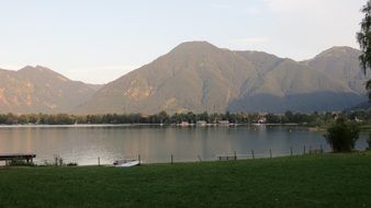 lake with green shores near the mountains