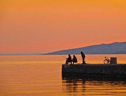 landscape of fishermen on the pier at dusk