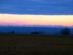 alpine mountains in the evening sky