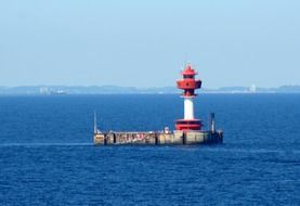 lighthouse in the ocean near the beach