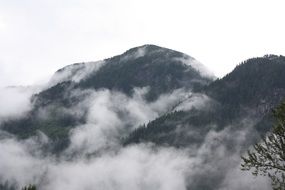 Mountains among white clouds in Canada