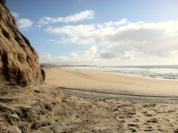 Landscape of the beautiful deserted sandy beach under a cloudy sky