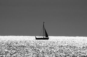 calm sailboat silhouette in sea