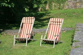 two sun loungers in the garden in summer