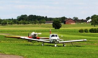 two sports aircraft in a meadow in thurgau