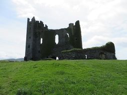 Castle on a green hill in ireland