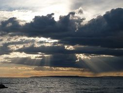 contrast seascape with dark clouds and sunrays